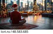 A person in a Santa hat meditates peacefully in a warmly decorated room while city lights twinkle in the background at sunset. Стоковое AI-изображение, AI-художник Данила Большаков / Фотобанк Лори