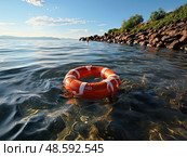 Life preserver gently floats amidst the rocky shores, serving as beacon of safety amidst the unpredictable waters. Стоковое AI-изображение, AI-художник Данила Большаков / Фотобанк Лори