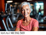 Older woman gracefully embraces her fitness routine at gym, radiating happiness with vibrant smile. Стоковое AI-изображение, AI-художник Данила Большаков / Фотобанк Лори