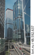 Modern skyscrapers reflect city skyline in bright daylight. Стоковое видео, видеограф Михаил Коханчиков / Фотобанк Лори