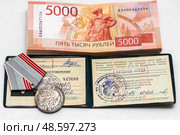 Медаль "Ветеран труда" и деньги лежит на удостоверение. Редакционное фото, фотограф Игорь Низов / Фотобанк Лори