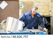 Belarus, Gomel, 25 April 2018. Factory for the manufacture of ventilation pipes.The worker at the factory makes ventilating metal pipes. Редакционное фото, фотограф Лазаренко Светлана / Фотобанк Лори