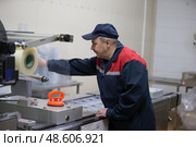 Belarus, the city of Gomel, on April 26, 2018. Meat plant. Working packer for packing machine. Редакционное фото, фотограф Лазаренко Светлана / Фотобанк Лори
