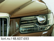 Aurus Komendant luxury premium SUV on display. Front right headlight. Редакционное фото, фотограф Антон Вахрушев / Фотобанк Лори