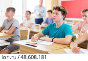 Teenager students sitting at desks. Стоковое фото, фотограф Яков Филимонов / Фотобанк Лори