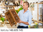 Man choosing small cabinet in store. Стоковое фото, фотограф Яков Филимонов / Фотобанк Лори