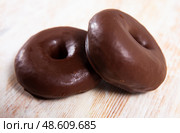 Two chocolate glazed donuts. Стоковое фото, фотограф Яков Филимонов / Фотобанк Лори