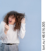 Morning routine for a curly haired person means pain tangled curls and desperate attempts to get ready and look presentable. Стоковое фото, фотограф Svetlana Golovco / Фотобанк Лори