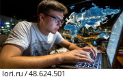 A man is typing on a laptop with a map of the world in the background. Стоковое AI-изображение, AI-художник Ярославский Максим / Фотобанк Лори