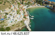 Colorful coastal village Asos with yachts and beach in a bay on Kefalonia island Greece. Стоковое видео, видеограф Igor Tichonow / Фотобанк Лори