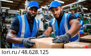 Two men wearing blue vests and hats are lifting a box. Стоковое AI-изображение, AI-художник Ярославский Максим / Фотобанк Лори