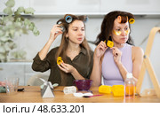Two women curling their hair with curlers. Стоковое фото, фотограф Яков Филимонов / Фотобанк Лори