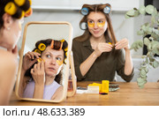 Two women curl their hair with curlers and use patches. Стоковое фото, фотограф Яков Филимонов / Фотобанк Лори