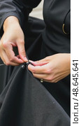 A close-up of a woman's hands sewing a black cloth banner, her fingers trembling slightly as she prepares for the Ashura process. Стоковое AI-видео, аниматор Sergey Grishin / Фотобанк Лори