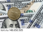 Close-up of a euro cent coin on US 100 dollar bills in focus. Стоковое фото, фотограф Емельянов Евгений Викторович / Фотобанк Лори
