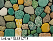 A captivating display showcases unakite and epidosite stones in various shapes and colors, highlighting their unique textures and natural beauty Generative AI. Стоковое AI-изображение, AI-художник Юлия Петровская / Фотобанк Лори