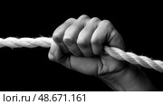 Strong hand gripping a thick rope in a dramatic black and white composition. Сильная рука держит толстый канат в драматической  композиции. Стоковое AI-изображение, AI-художник Katsiaryna Repich / Фотобанк Лори