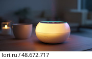 Virtual assistant represented as a glowing orb of data. dot home assistant smarthome speaker. Intelligent home assistant hub, glowing touch interface, minimal style. Стоковое AI-изображение, AI-художник ALLA YURTAYEVA / Фотобанк Лори