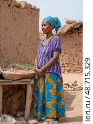Street vendor selling local produce in rural african village. Стоковое AI-изображение, AI-художник Юрий Поздников / Фотобанк Лори