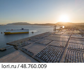 New Cars on Parking Lot and ro-ro Cargo Ship in Port of Setubal. Aerial View. Стоковое фото, фотограф Максим Забаровский / Фотобанк Лори