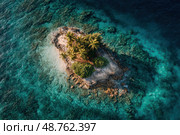 A small island with palm trees and a small hut sits in the middle of the ocean. Стоковое AI-изображение, AI-художник Ярославский Максим / Фотобанк Лори