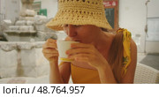 Smiling woman enjoying cappuccino at street cafe in Atrani town center. Стоковое видео, видеограф Ольга Сухарева / Фотобанк Лори