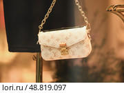 LILLE, FRANCE - FEBRUARY 21,2024 : Bag Louis Vuitton in the shop window at store. Редакционное фото, фотограф Irina Kuchugurina/Gaudy / Фотобанк Лори