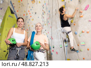two active female marathon participants are standing in climbing hall. Стоковое фото, фотограф Яков Филимонов / Фотобанк Лори