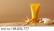 Yellow Sunscreen cream tube, starfishes and seashells on a sand top view. Cosmetic mockup. Sunblock lotion on sandy beach background. Summer vacation care concept, sun screen product, spf uv protect. Стоковое AI-изображение, AI-художник Марина Демидюк / Фотобанк Лори
