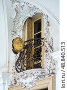 Marseille, France - Nov 2 2018, panoramic view of the facade of an old house with a balcony on which French emblem of the notary's office is located, at daytime, without people, Marseille, France. Стоковое фото, фотограф Сергей Богомяко / Фотобанк Лори