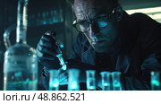A scientist wearing glasses and gloves carefully works in a dark lab with many test tubes and pipettes. Стоковое AI-изображение, AI-художник Данила Большаков / Фотобанк Лори