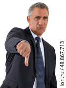 Disapproving businessman giving the thumb&rsquo;s down. Стоковое фото, агентство Ingram Publishing / Фотобанк Лори