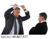 Angry boss about to hit employee with clip-board. Стоковое фото, агентство Ingram Publishing / Фотобанк Лори