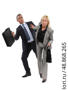 businesswoman pushing a colleague. Стоковое фото, агентство Ingram Publishing / Фотобанк Лори