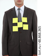 Businessman covered in yellow memo pads. Стоковое фото, агентство Ingram Publishing / Фотобанк Лори