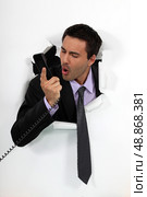 A businessman yelling at his phone. Стоковое фото, агентство Ingram Publishing / Фотобанк Лори