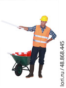 Foreman with plans and a barrow of traffic cones. Стоковое фото, агентство Ingram Publishing / Фотобанк Лори