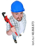 Builder with an adjustable wrench. Стоковое фото, агентство Ingram Publishing / Фотобанк Лори