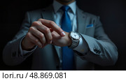 Мужчина в деловом костюме указывает пальцем на часы / A man in a business suit points at his watch. Стоковое AI-изображение, AI-художник Валерий Лукин / Фотобанк Лори