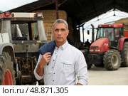 A farmer posing with his tractors. Стоковое фото, агентство Ingram Publishing / Фотобанк Лори