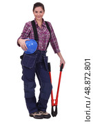 Female construction worker holding a large tool. Стоковое фото, агентство Ingram Publishing / Фотобанк Лори