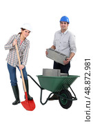 female bricklayer with shovel and male counterpart. Стоковое фото, агентство Ingram Publishing / Фотобанк Лори