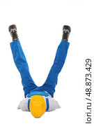 Builder on his back with his legs in a V. Стоковое фото, агентство Ingram Publishing / Фотобанк Лори