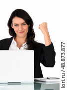 Businesswoman holding a triumphant fist in the air. Стоковое фото, агентство Ingram Publishing / Фотобанк Лори