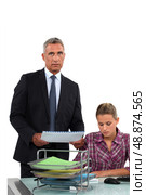 Businessman giving his overworked assistant more work. Стоковое фото, агентство Ingram Publishing / Фотобанк Лори