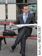 Businessman reading a newspaper on a bench. Стоковое фото, агентство Ingram Publishing / Фотобанк Лори