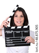 Brunette woman with movie slate. Стоковое фото, агентство Ingram Publishing / Фотобанк Лори