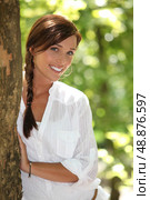 Woman peeking out from behind a tree. Стоковое фото, агентство Ingram Publishing / Фотобанк Лори