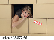 woman surrounded  by cartons. Стоковое фото, агентство Ingram Publishing / Фотобанк Лори