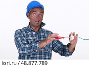 Tradesman suffering from electric shock. Стоковое фото, агентство Ingram Publishing / Фотобанк Лори